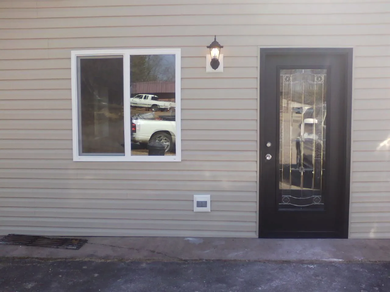 New siding, window and entry door on the side of an addition in Horicon